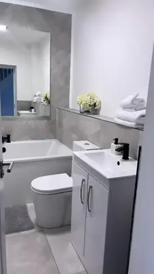 a bathroom with a toilet and a tub and a sink at 3 Bedroom House Near City Centre Glasgow Sleeps 7 in Glasgow