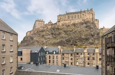 a castle on top of a hill with buildings at Edinburgh Castle Apartment G1 in Edinburgh