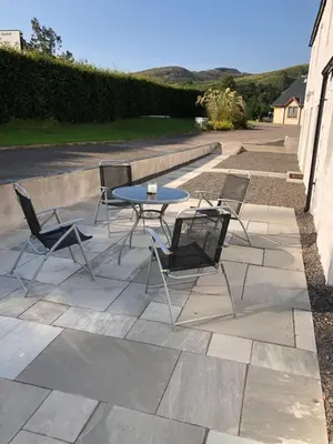 a table and chairs sitting on a patio at Old Tynribbie House - Comfortable Detached House in Appin