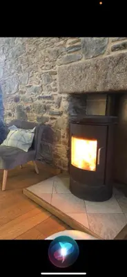 a stone fireplace in a living room with a couch at Old Tynribbie House - Comfortable Detached House in Appin