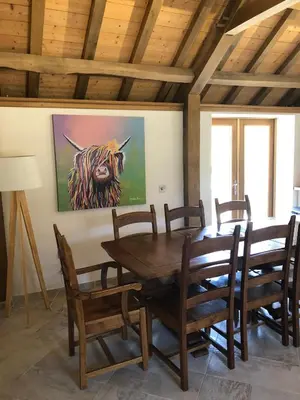a dining room with a wooden table and chairs at Old Tynribbie House - Comfortable Detached House in Appin