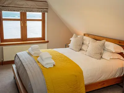 a bedroom with a bed with towels on it at Kringlands in Stranraer