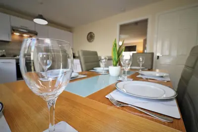 a table with a wine glass on top of it at Signature - Harris House in Glasgow
