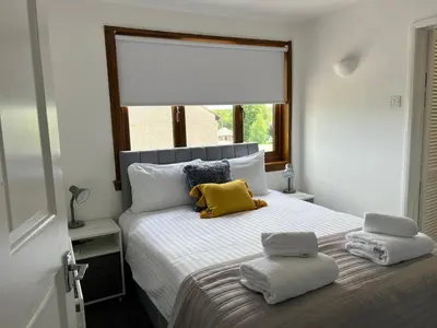 a bedroom with a bed with two pillows on it at Signature - Barons Court in Paisley