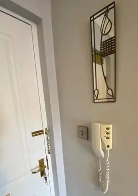 a phone on a wall next to a door at NEW Super 2 Bedroom Flat in Falkirk in Falkirk