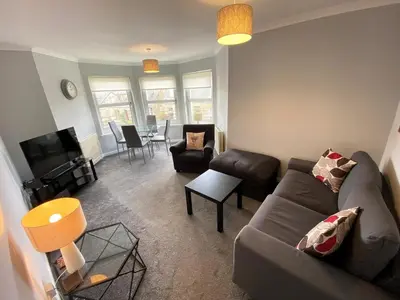 a living room with a couch and a table at NEW Super 2 Bedroom Flat in Falkirk in Falkirk