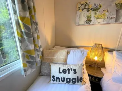 a small room with two beds and a window at Beautiful 3BR Holiday Home in Stunning Location - Pass the Keys in Moffat