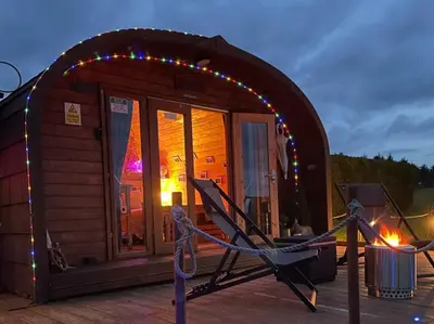 a small cabin with a string of lights at FINN VILLAGE - Loch Lomond Sunset Glamping Pod - Private Ofuro HOT TUB in Drymen