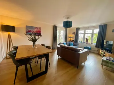 a living room with a table and a couch at Turnberry Apartment - Ailsa Gem in Turnberry