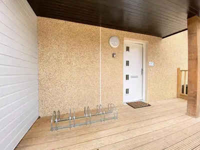a bench in a room with a wall and a door at Beautiful Riverside Holiday Home in Callander