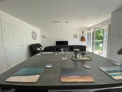 a living room with a table and a couch at Beautiful Riverside Holiday Home in Callander