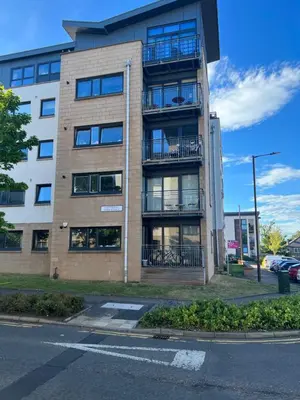 an apartment building with balconies on the side of a street at Strada Apartment in Edinburgh