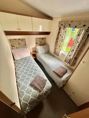 a small room with two beds and a window at 2-Bedroom Caravan Located in Uddingston, Glasgow at Maryville Caravan Site in Uddingston