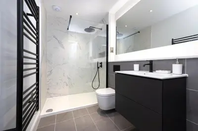 a bathroom with a shower and a toilet and a sink at Dragon Suites Luxury Serviced Apartments at Alva Street in Edinburgh