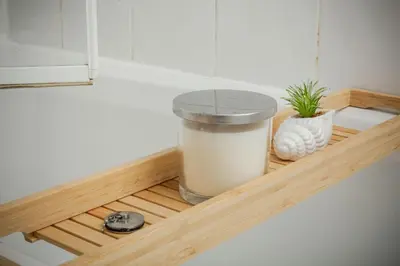 a wooden shelf with a trash can and a plant at Bonhill Getaway in Dumbarton