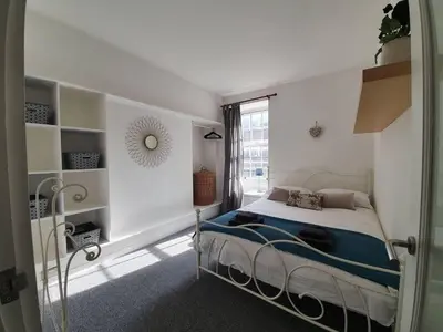 a bedroom with a bed in a room with a window at Lovely 2 bedroom flat in the heart of the city in Edinburgh