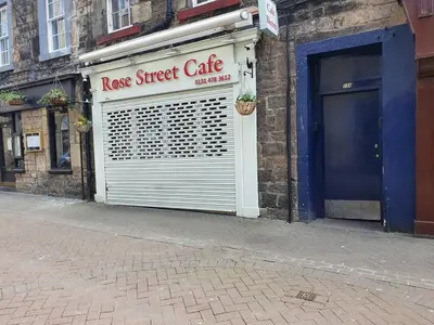 a store with a garage door and a race street cafe at Lovely 2 bedroom flat in the heart of the city in Edinburgh