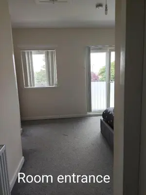 an empty room with two windows and a couch at My room in Edinburgh