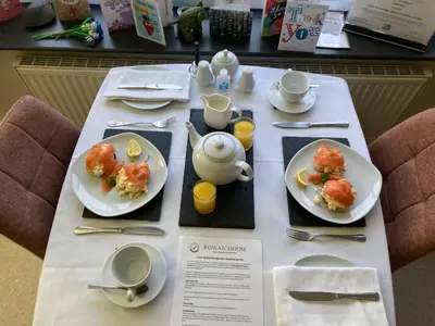 a table with two plates of food on it at Rowan House B&B Rooms & A Self Catering Apartment in Lochgoilhead