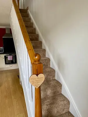 a wooden stair railing with a wooden heart sign on it at Rowan House B&B Rooms & A Self Catering Apartment in Lochgoilhead