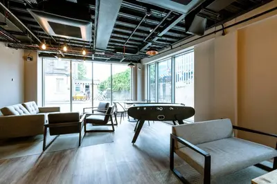a living room with a pool table and chairs at Modern Studio Apartments at Murieston Crescent in Edinburgh in Edinburgh