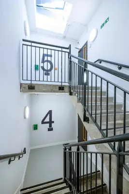a staircase in a building with a number four on the wall at Modern Studio Apartments at Murieston Crescent in Edinburgh in Edinburgh