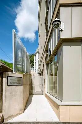 a building with a sign on the side of it at Modern Studio Apartments at Murieston Crescent in Edinburgh in Edinburgh