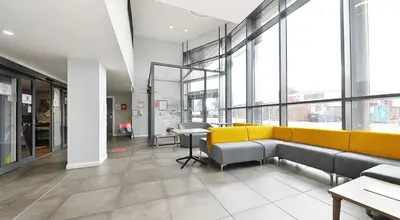 a lobby with couches and tables in a building at HFS The Mill House Edinburgh in Edinburgh