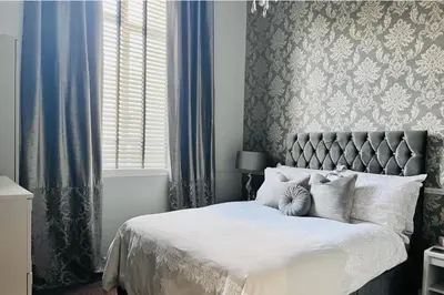 a bedroom with a large bed with white pillows at Apartment with City Views - Sleeps 3 in Edinburgh