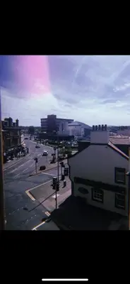 a view of a city street with a rainbow in the sky at Dalblair Apartment in Ayr