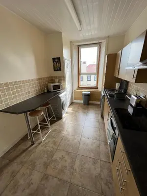 a kitchen with a sink and a counter top at Dalblair Apartment in Ayr