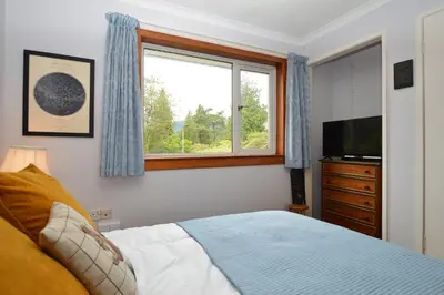 a bedroom with a bed and a window and a television at Brookfield in Sandbank