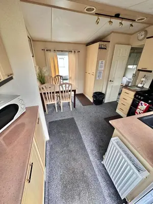 a kitchen and dining area of an rv at 2 Bedroom Caravan Located in Uddingston, Glasgow at Maryville Caravan Site in Uddingston