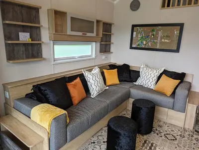 a living room with a couch with pillows at The Cuddies in Balloch
