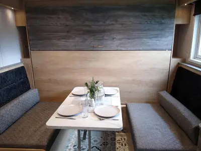a table with two chairs and a white table with plates at The Cuddies in Balloch