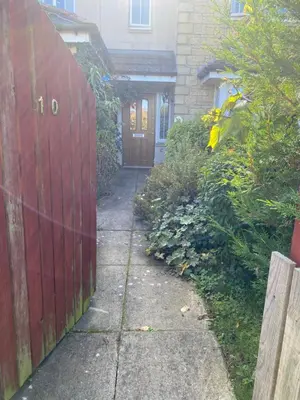 a driveway leading to a house with a red fence at Caledonia House in Rosyth