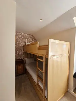 a small bedroom with a bunk bed with a ladder at Taychreggan, Signature Collection by Eight Continents in Oban
