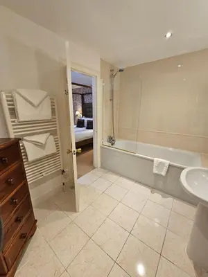 a bathroom with a bath tub and a sink at Taychreggan, Signature Collection by Eight Continents in Oban