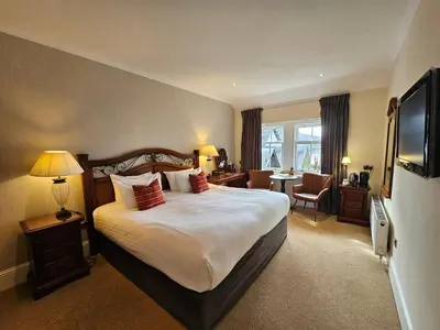 a hotel room with a bed and a television at Taychreggan, Signature Collection by Eight Continents in Oban