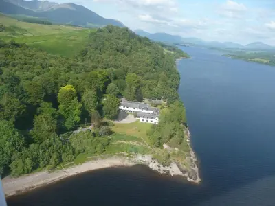 an aerial view of a house on an island in the water at Taychreggan, Signature Collection by Eight Continents in Oban