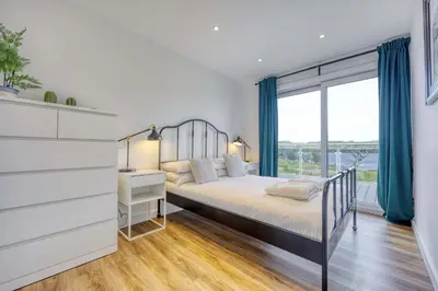 a bedroom with a bed and a large window at New Build Lodge With Stunning Views of Loch Awe in Hayfield
