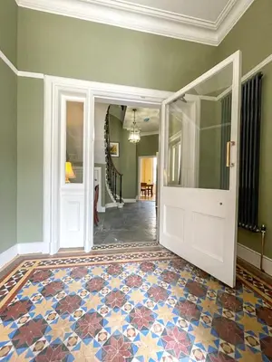 an empty room with a door and a tile floor at Remarkable 5BR Townhouse with Garden, Sleeps 12 in Edinburgh