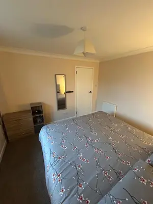 a bedroom with a bed with a blue comforter at Viewlands house in Auchterarder