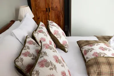 a white bed with four pillows on it at JOIVY Cozy Apt near Edinburgh Castle in Edinburgh