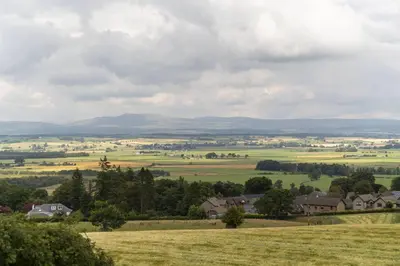 a view of a field with houses and trees at St Michael's in Kippen