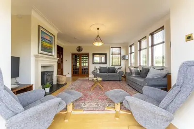 a living room with couches and a fireplace at St Michael's in Kippen