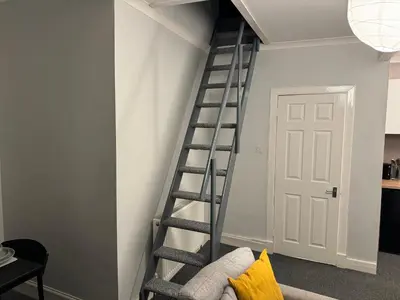 a ladder leading up to a room with a wall at Nelson st (YELL) in Largs