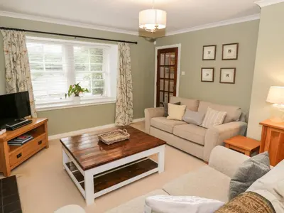 a living room with a couch and a coffee table at Greystones Cottage in Crieff