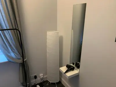a bathroom with a mirror and a table with a camera at Nelson st (ANNAN) in Largs