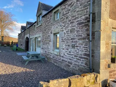 a picnic bench next to a brick building at The Granary in Stirling